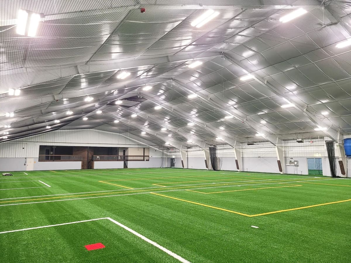Livonia Athletic District's indoor turf soccer field lit up